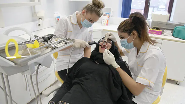 Dental Nursing Apprentices learning with a patient